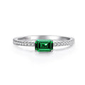Green emerald-cut cubic zirconia ring with side stones in sterling silver