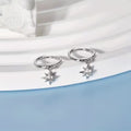 Sterling silver huggie hoops with a starburst charm