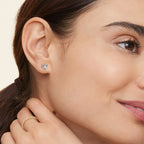 Silver heart moissanite stud earring worn on the ear