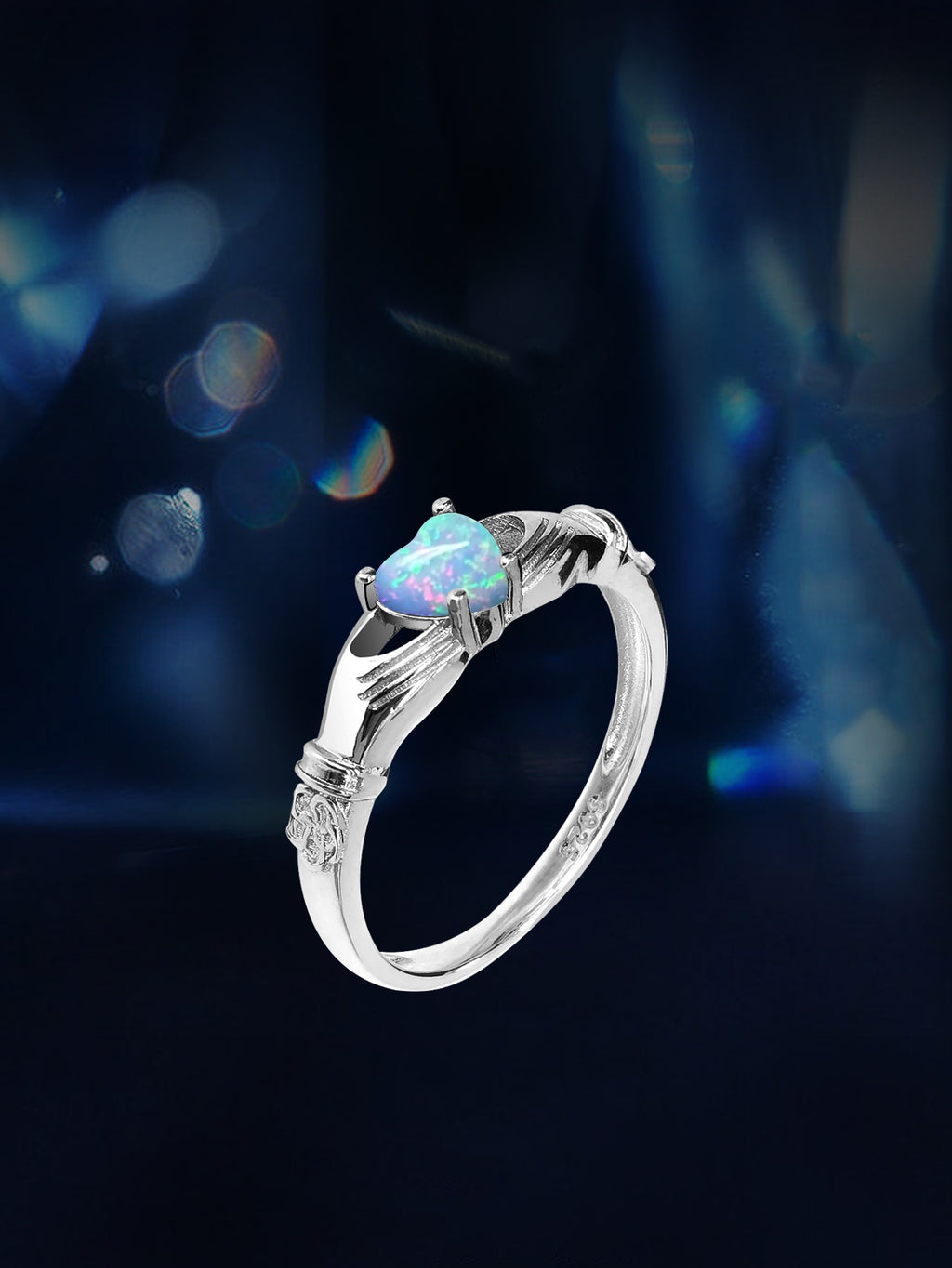 Claddagh ring with Celtic knot shoulders and an opal heart