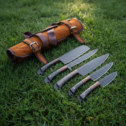 Set of knives with a leather sheath on grass