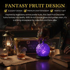 Fantasy fruit design decanter with purple glass and golden stem on a table with glasses and a lantern.